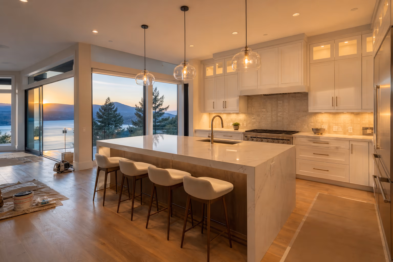 Modern kitchen renovation in a West Kelowna hillside home with Okanagan Lake views — custom cabinetry, quartz island, warm sunset light — Nailed It Developments